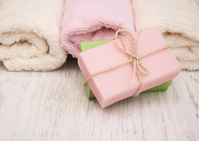 Bath towels and handmade soap on a old wooden background